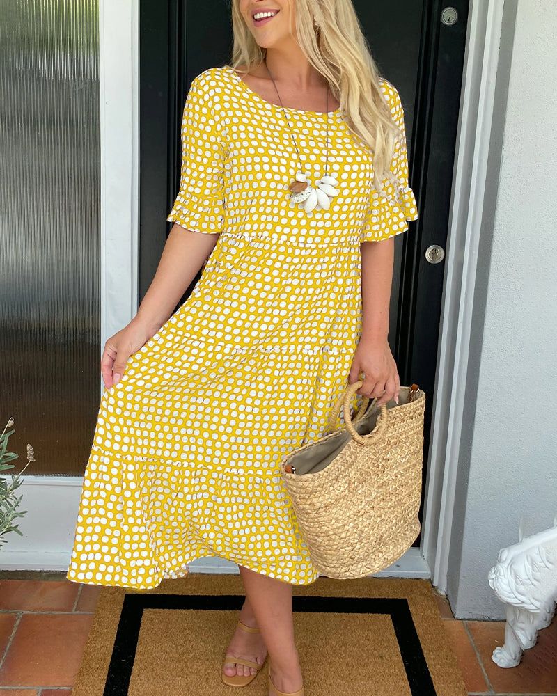 Yellow patterned summer dress with short sleeves and white daisy applique at chest