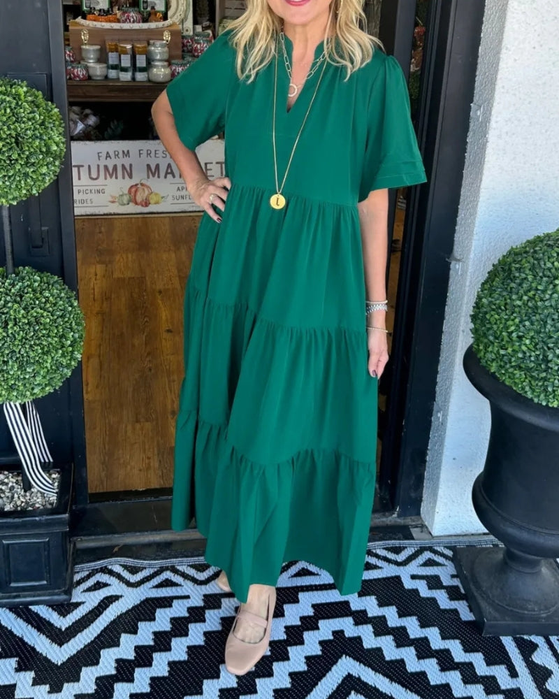 Green tiered maxi dress with short sleeves, V-neck, and keyhole opening