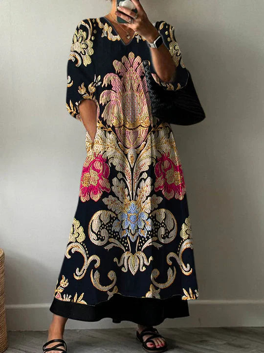 V-neck black printed dress with ornate floral and scroll pattern, long sleeves, midi length