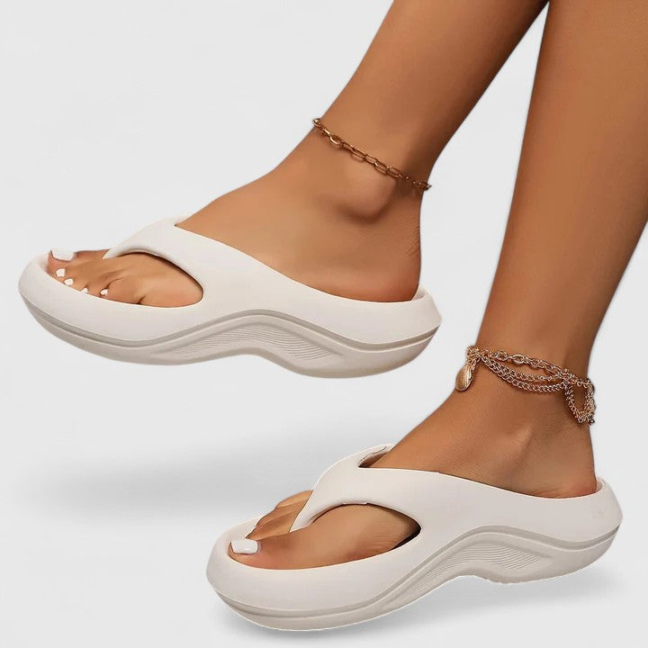 Comfort slide sandals in white with cushioned sole and wavy sidewalls