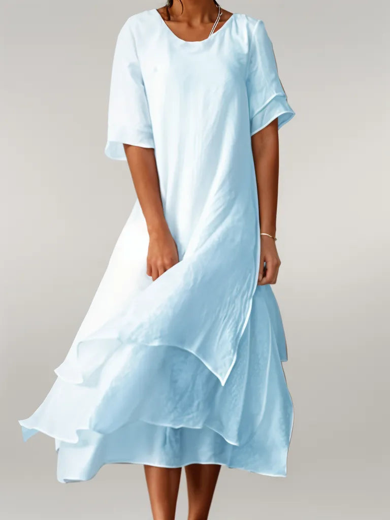 Blue cotton long dress with short sleeves, round neck, and layered ruffle hem
