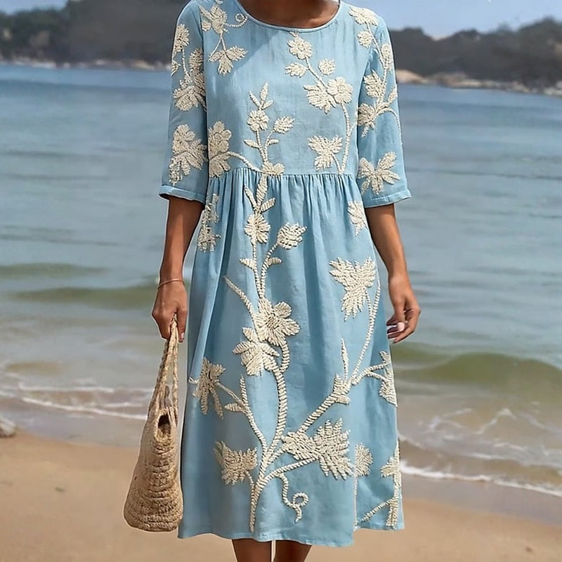 Blue casual dress with cream floral print, flared skirt, 3/4 sleeves, round neckline