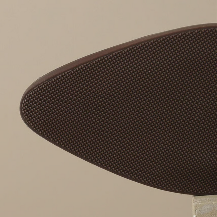 Brown outsole for ankle boots with textured tread pattern and grippy edge