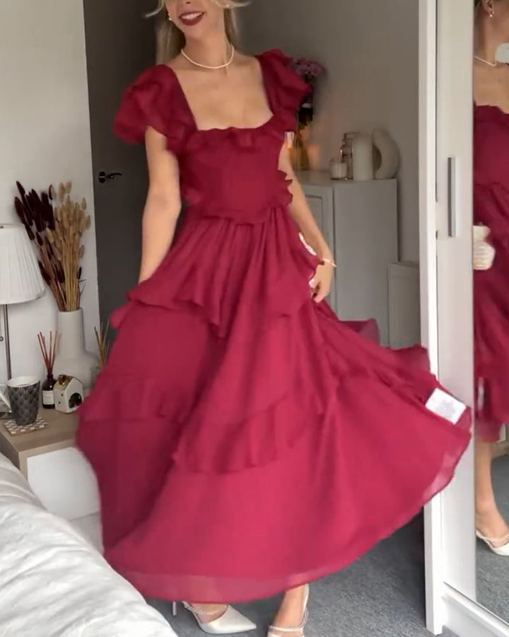 Magenta tiered midi ruffle dress with puff sleeves and a flowing skirt