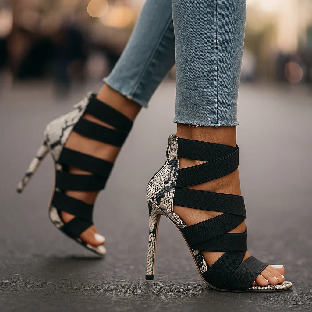 Black strappy stiletto sandal with snake-print heel and open toe