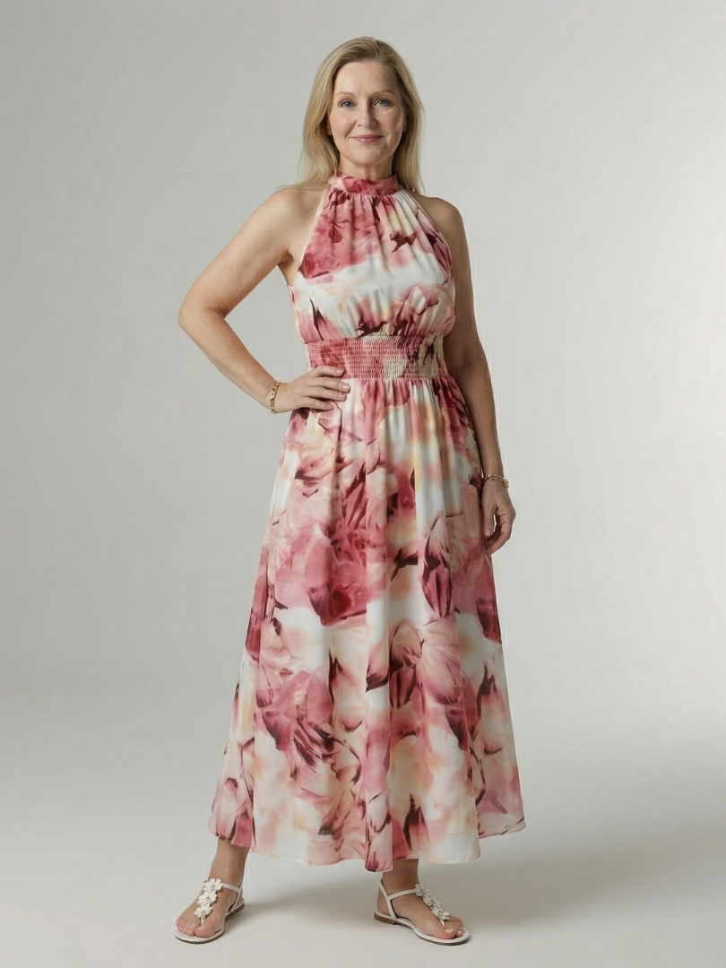 Pink floral gathered halter midi dress with ruched neckline and full flowing skirt.