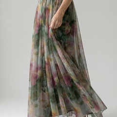 Multicolor maxi dress on model, V-neck with wrap bodice and flowing pleated skirt, side view.