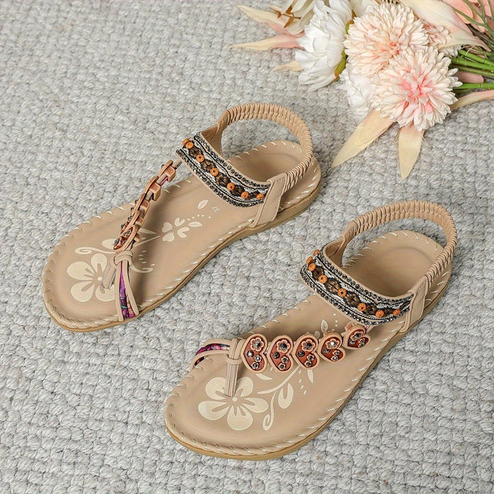 Beige slide sandals with floral print insole and beaded toe ornament