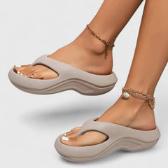 Comfort slide sandals in light gray with contoured footbed and wavy sole