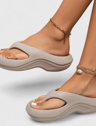 Comfort slide sandals in light gray with contoured footbed and wavy sole