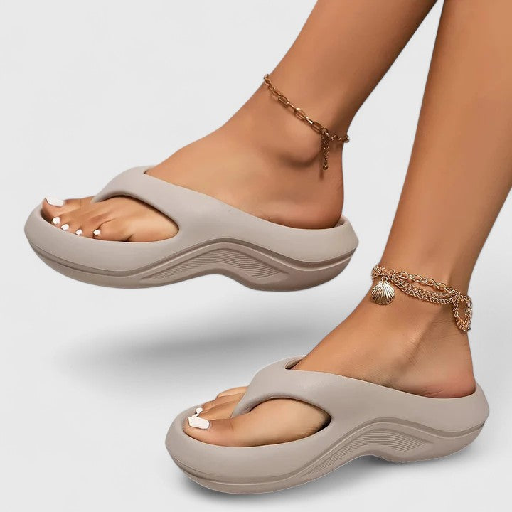 Comfort slide sandals in light gray with contoured footbed and wavy sole