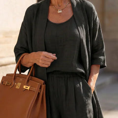 Black women's elegant set close-up: scoop-neck top with matching wide-leg pants