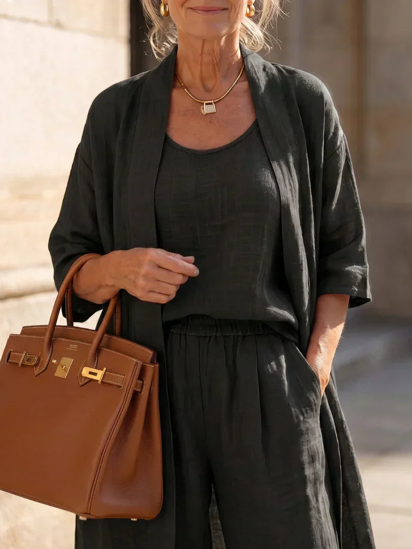 Black women's elegant set close-up: scoop-neck top with matching wide-leg pants
