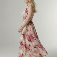 Pink floral gathered halter midi dress, side view with sleeveless halter neckline.