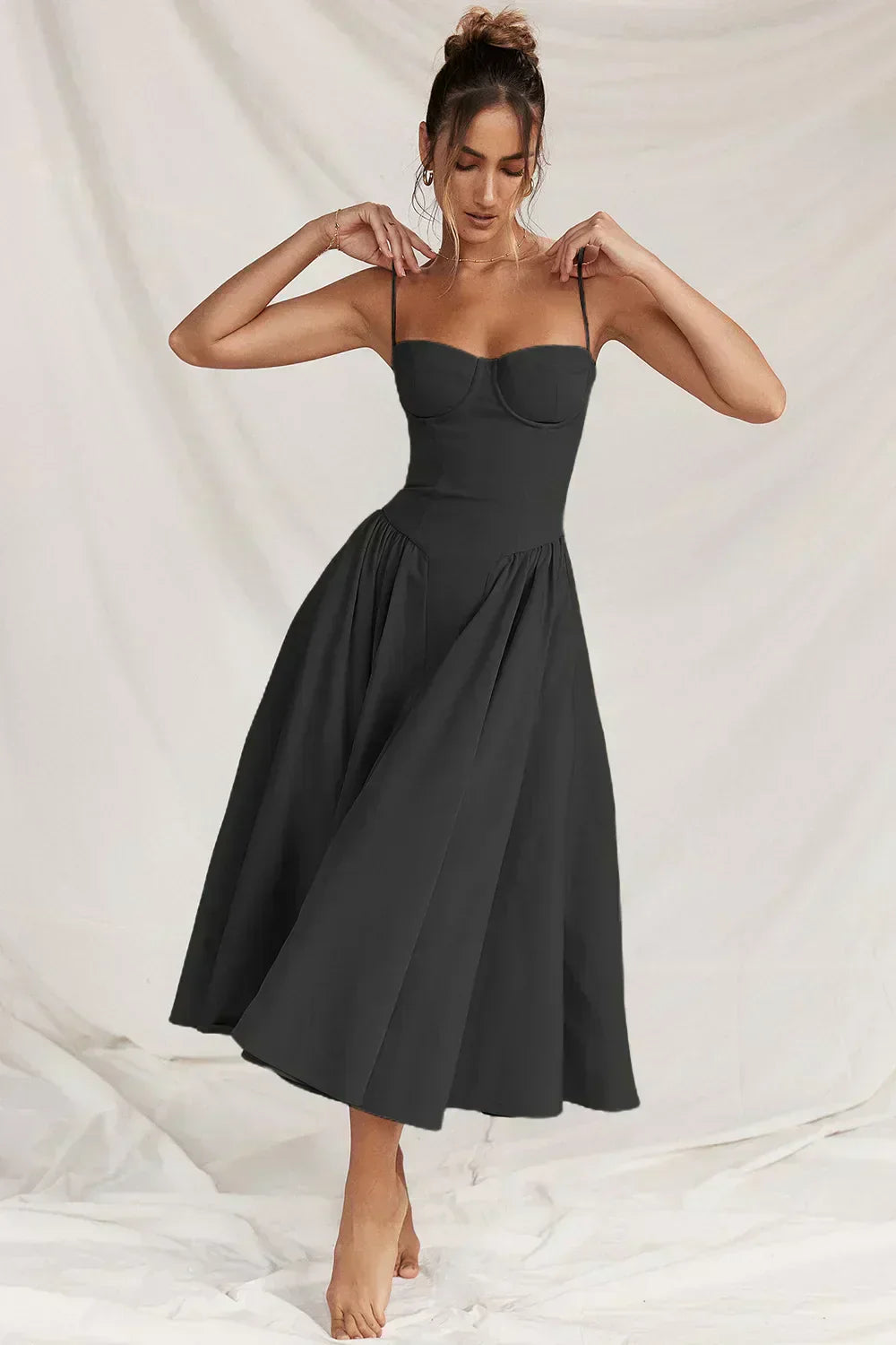 Black corset sundress with spaghetti straps and full pleated skirt
