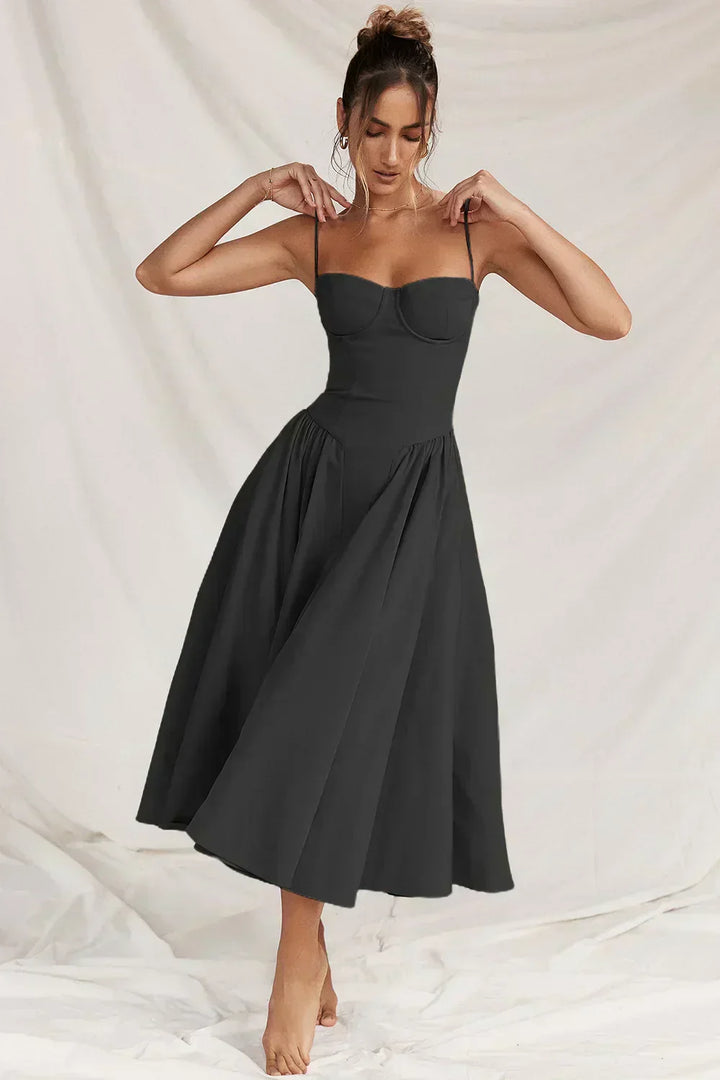 Black corset sundress with spaghetti straps and full pleated skirt