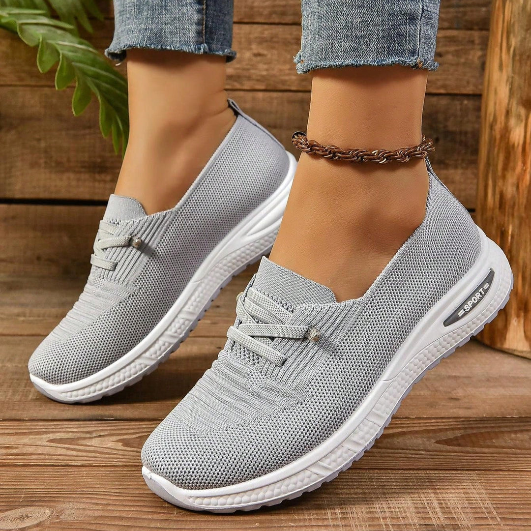 Gray lace-up knit sneakers with white soles and padded collar