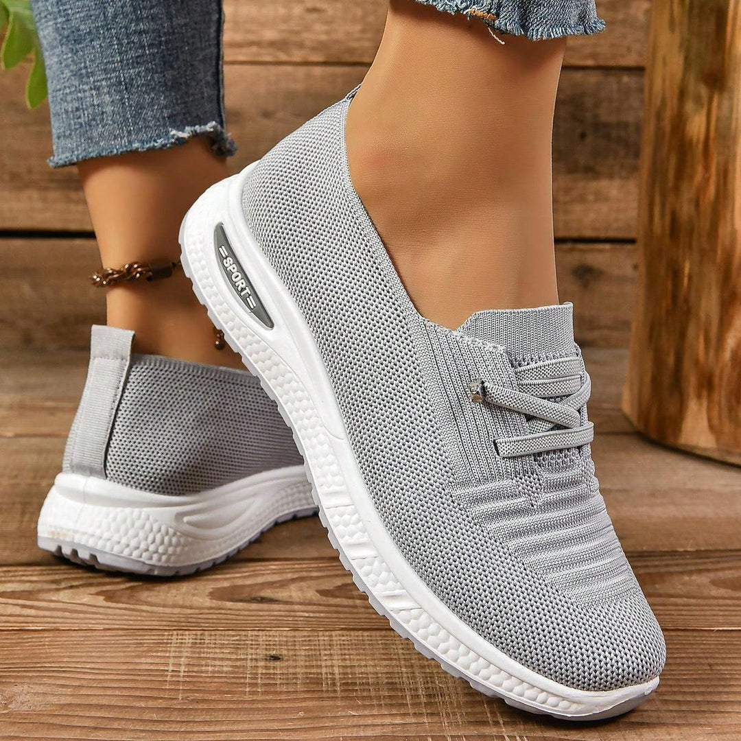 Gray lace-up knit sneakers with white cushioned sole and textured pattern
