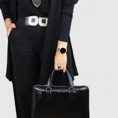 Black three-piece outfit with long blazer, short top, and wide-leg pants