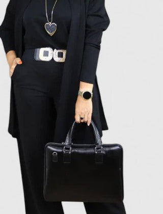 Black three-piece outfit with long blazer, short top, and wide-leg pants