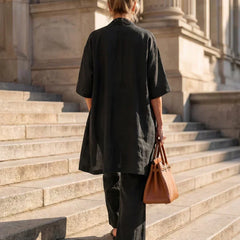Black women's elegant set, back view: short-sleeve cardigan over wide-leg pants