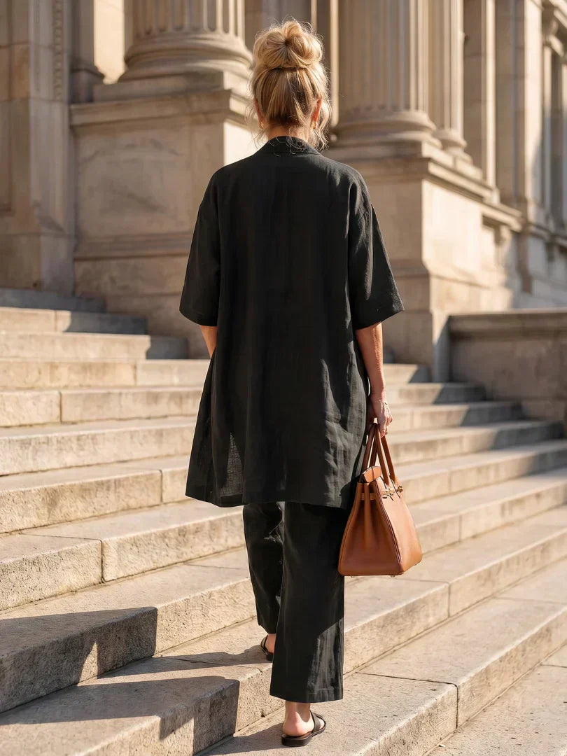 Black women's elegant set, back view: short-sleeve cardigan over wide-leg pants