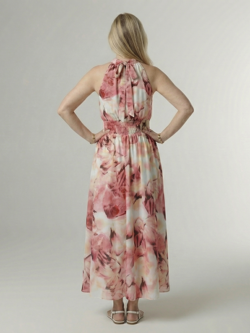 Pink floral gathered halter midi dress with tied halter back and full skirt.