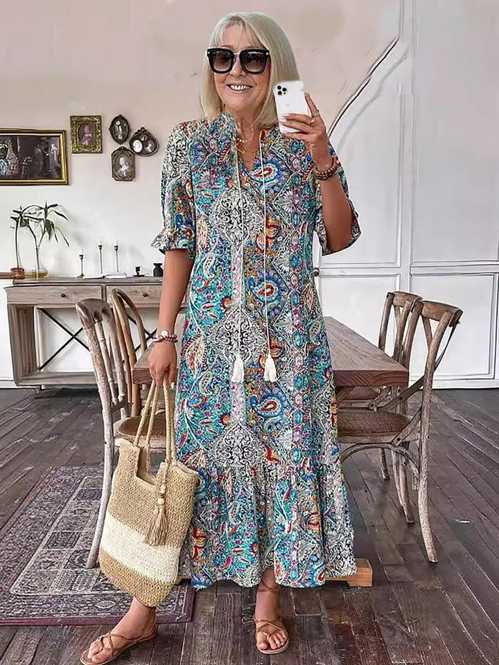 Blue paisley Boho Grace dress with short puff sleeves and tassel-tie neckline