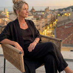 Black women's elegant set on rooftop: draped cardigan with matching wide-leg pants