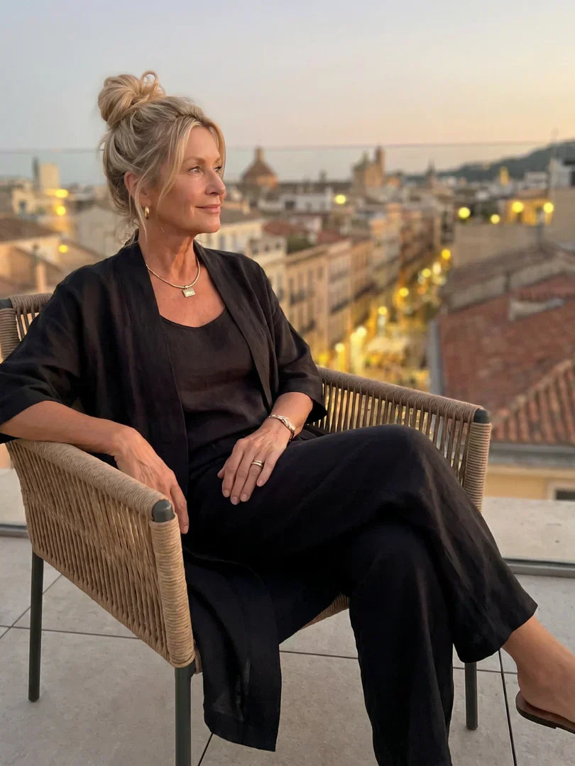 Black women's elegant set on rooftop: draped cardigan with matching wide-leg pants