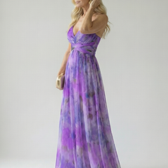 Purple maxi dress with V-neck wrap bodice and crisscross waist, sleeveless spaghetti straps, side view.