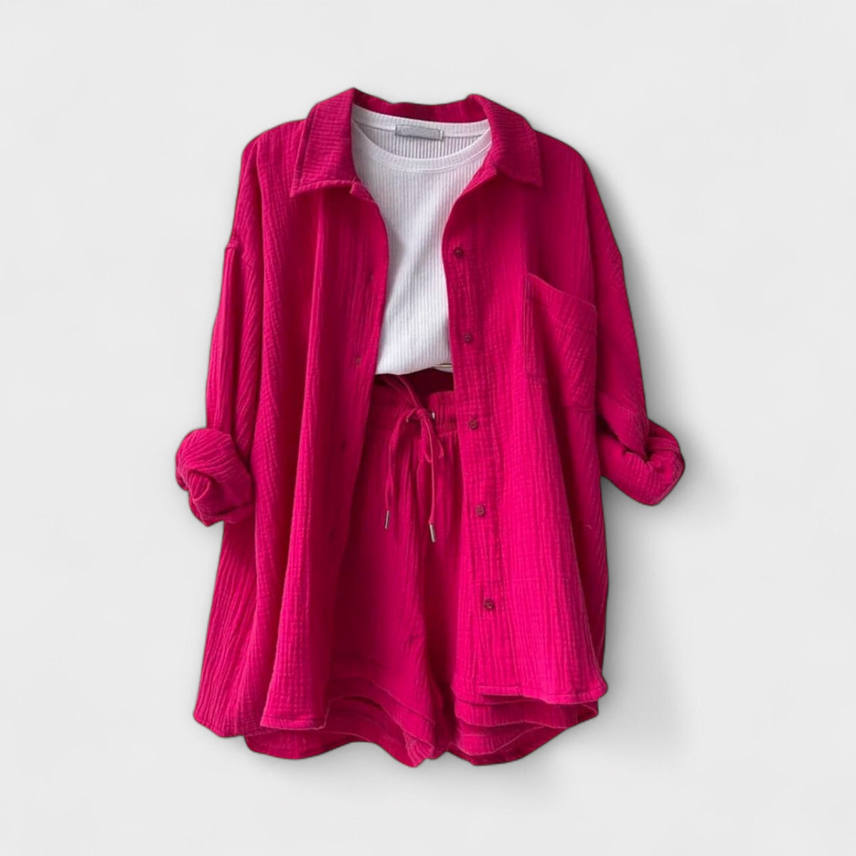 Pink two-piece set: button-front shirt with pockets over drawstring shorts