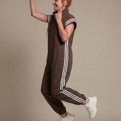 Brown jumpsuit with front zipper, hood drawstrings, and white stripe side panels