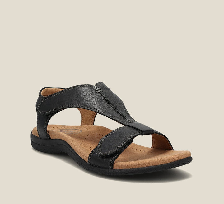 Black orthopedic vegan leather sandal with open toe, wide strap, and cushioned sole.