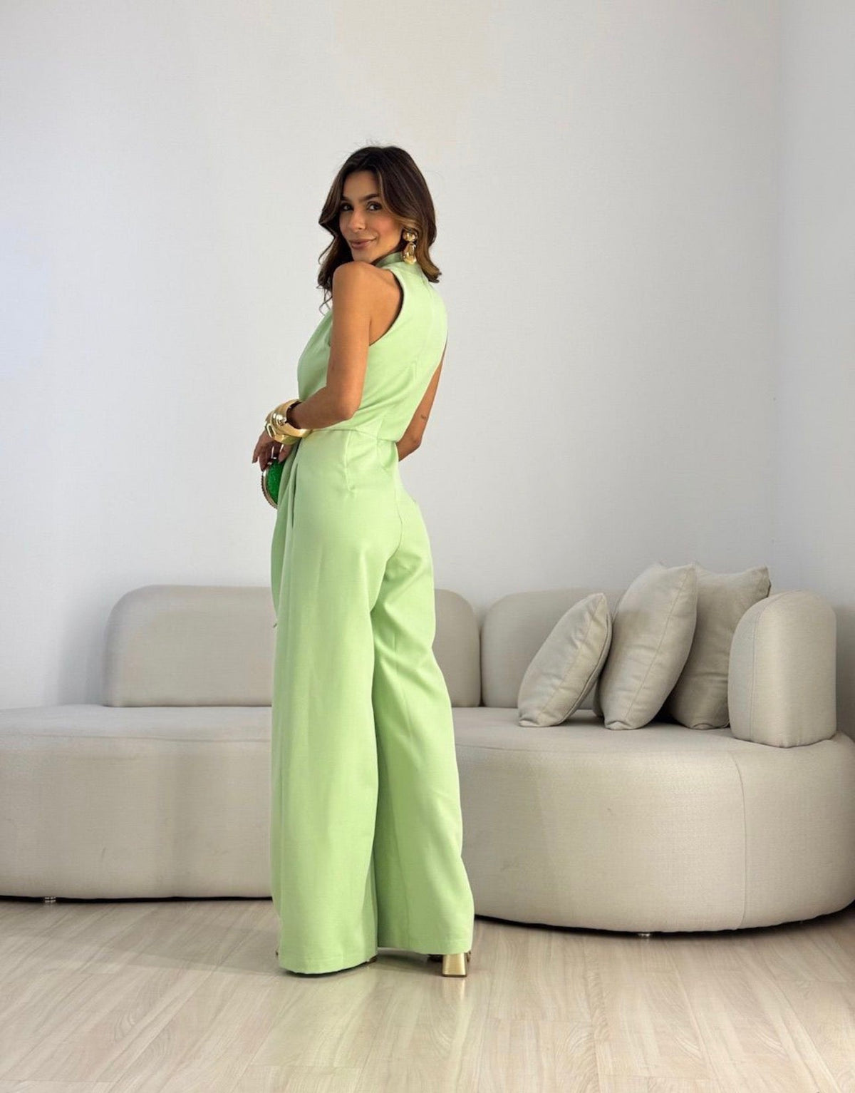 Neon light green sleeveless jumpsuit with wrap V-neck and tied waist, wide-leg