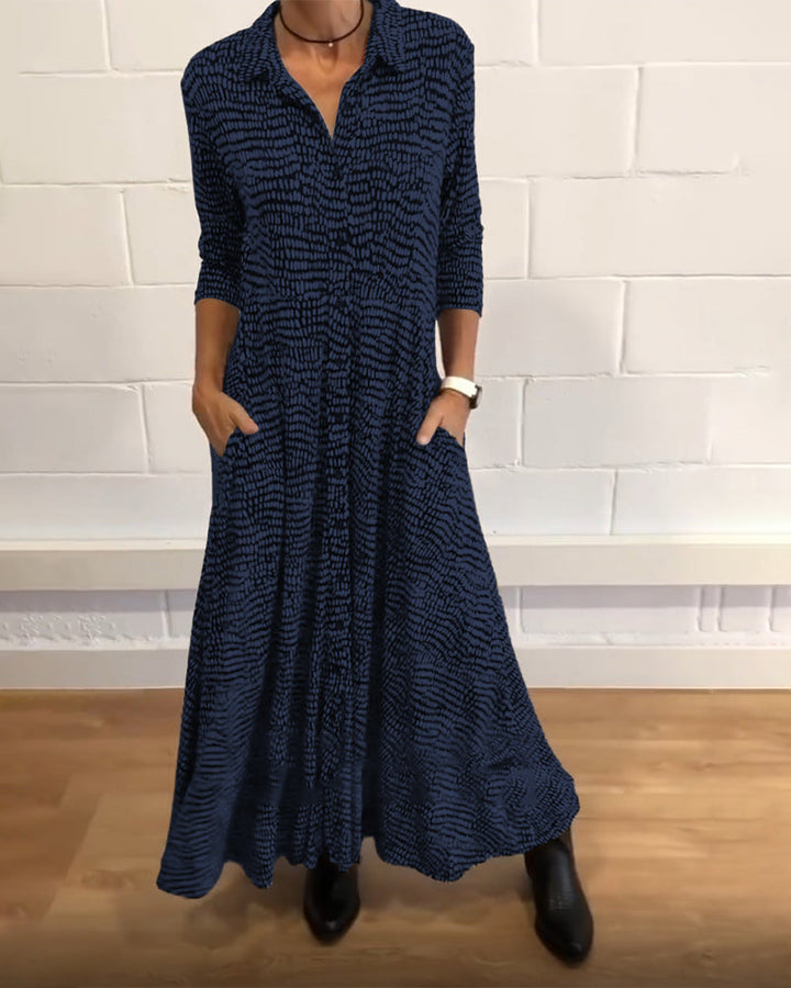 Blue patterned midi dress with V-neck, three-quarter sleeves, side pockets