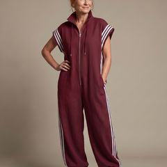 Burgundy zip-front jumpsuit with white striped sleeves and side stripes