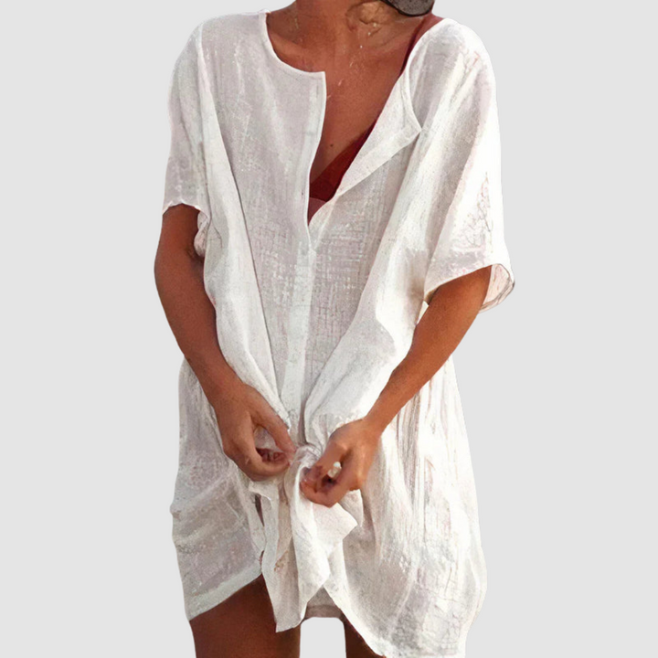 White soft loose fit dress with V-neck, short sleeves, and front tie knot.