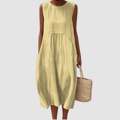 Yellow sleeveless midi dress with embroidered eyelet clover pattern, tiered skirt