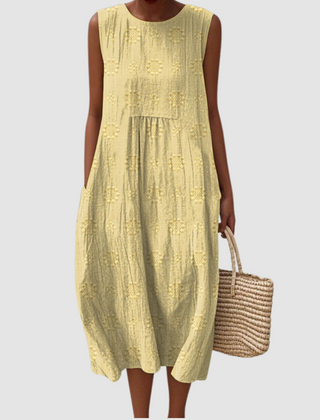 Yellow sleeveless midi dress with embroidered eyelet clover pattern, tiered skirt