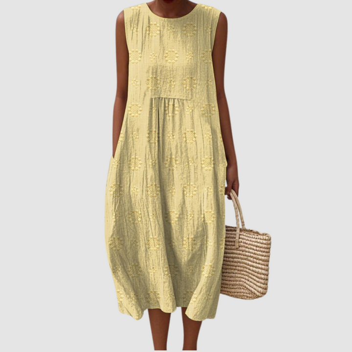Yellow sleeveless midi dress with embroidered eyelet clover pattern, tiered skirt
