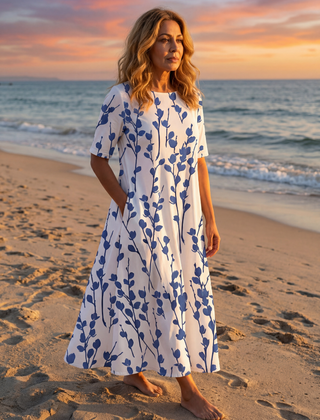White floral midi dress with short sleeves and gathered skirt, front view