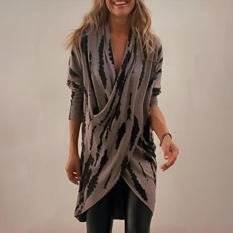 Asymmetrical V-neck tunic with dark gray and black abstract print, loose drape