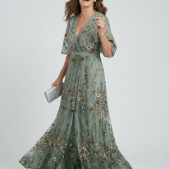 Sage green halter V-neck maxi dress with floral print, short sleeves and flowing tiered skirt