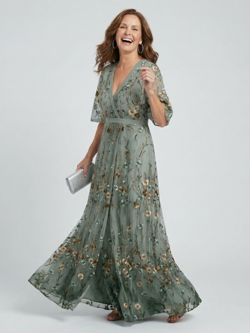 Sage green halter V-neck maxi dress with floral print, short sleeves and flowing tiered skirt