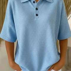 Blue waffle knit polo blouse with short sleeves, pointed collar, three-button placket