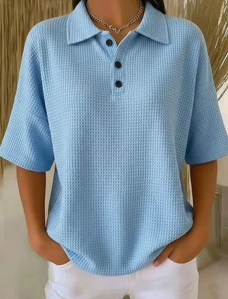 Blue waffle knit polo blouse with short sleeves, pointed collar, three-button placket