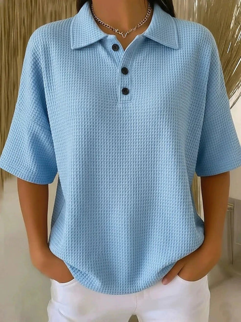 Blue waffle knit polo blouse with short sleeves, pointed collar, three-button placket