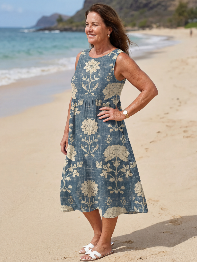Blue sleeveless midi dress with large cream flower and vine pattern