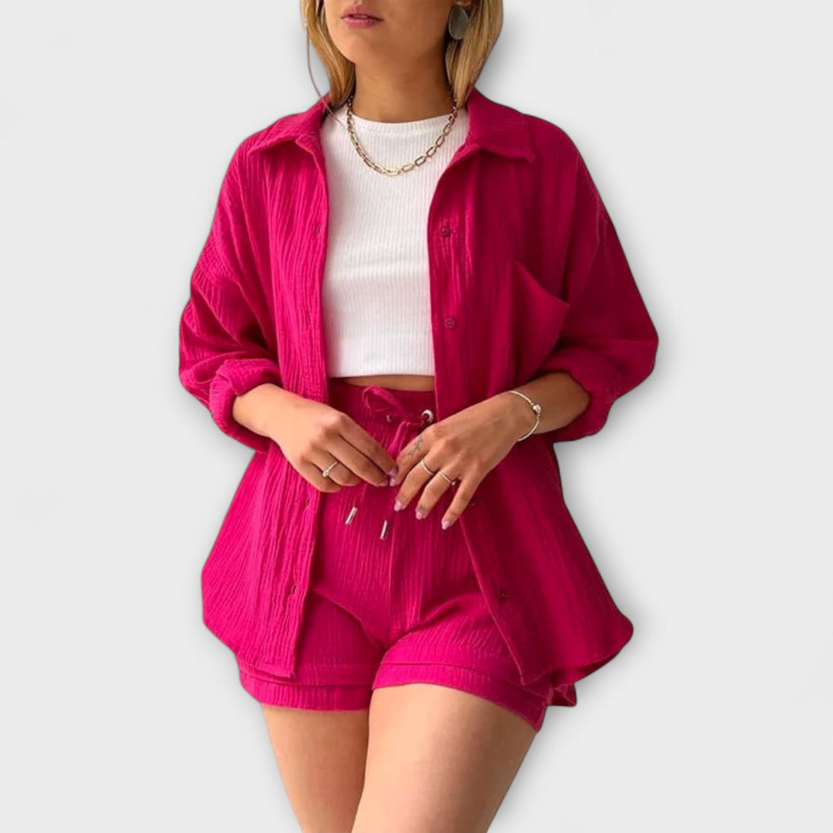 Pink two-piece set with button-front shirt and drawstring-waist shorts